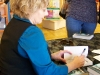 Faith Hunter autographing a book for a fan.