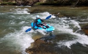 Faith Hunter paddling white water